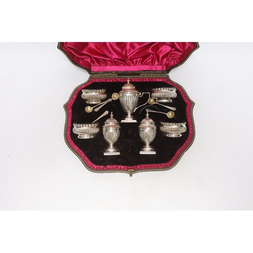 889 - A cased late Victorian seven piece silver condiment set, Josiah Williams & Co Ltd, London, 1898, wit... 