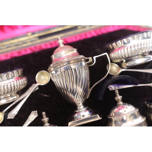 889 - A cased late Victorian seven piece silver condiment set, Josiah Williams & Co Ltd, London, 1898, wit... 