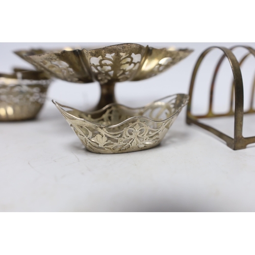 893 - A small silver basket, a pierced silver pedestal dish, a George V silver five bar toast rack and a p... 