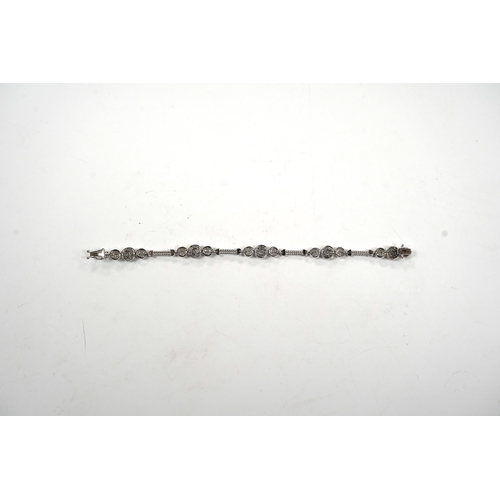 911 - A modern 14k white metal and diamond cluster set line bracelet, the total diamond weight approximate... 