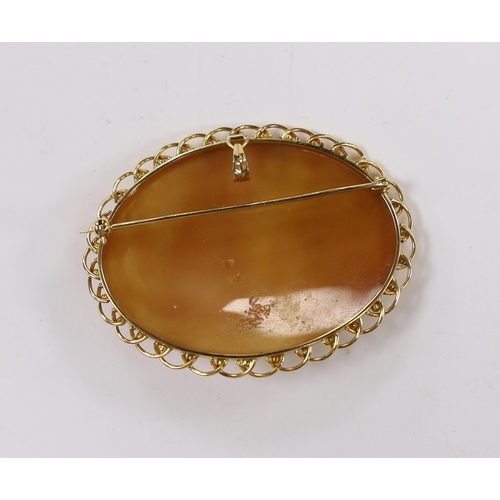 932 - A modern 18k mounted oval cameo shell pendant brooch, carved with Phoebus and the hours preceded by ... 