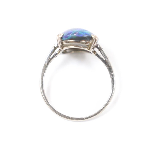 937 - An 18ct, plat and single stone cabochon black opal set ring, with six stone diamond chip set shoulde... 