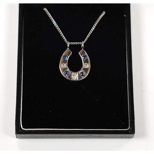 975 - A modern 18ct white gold, sapphire and diamond set horseshoe pendant on chain, overall 44cm, gross w... 