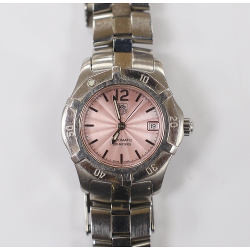 976 - A lady's modern stainless steel Tag Heuer automatic wrist watch, with pink dial, on a Tag Heuer stai... 