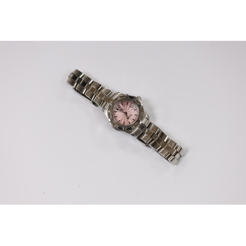 976 - A lady's modern stainless steel Tag Heuer automatic wrist watch, with pink dial, on a Tag Heuer stai... 