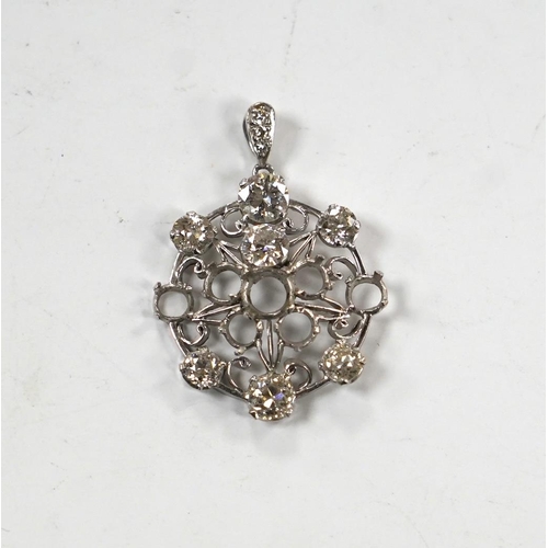 984 - A white metal and diamond cluster set circular pendant (seven stones missing), largest stone diamete... 