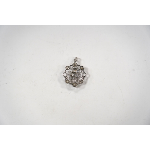 984 - A white metal and diamond cluster set circular pendant (seven stones missing), largest stone diamete... 