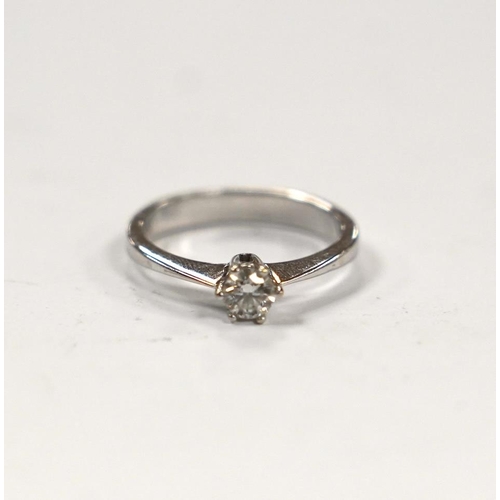 986 - A 14k white metal and solitaire diamond set ring, size H, gross weight 2 grams.