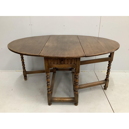 99 - A reproduction 18th century style oak gateleg dining table, width 106cm, depth 50cm, height 73cm... 