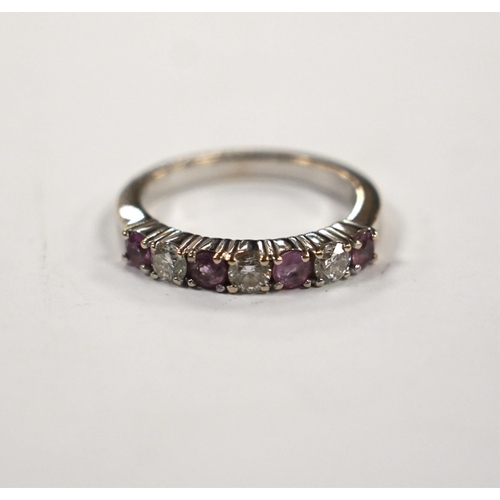 999 - A modern 18ct white gold, three stone diamond and four stone pink sapphire? set half hoop ring, size... 