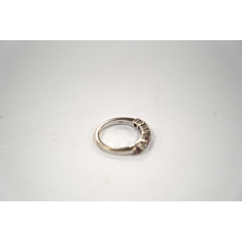 999 - A modern 18ct white gold, three stone diamond and four stone pink sapphire? set half hoop ring, size... 