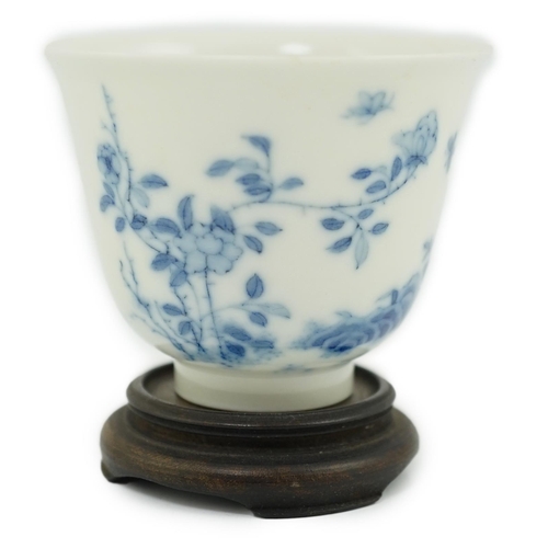101 - A Chinese blue and white 'month' cup, Kangxi mark, probably late 19th century, painted with shrubs a... 