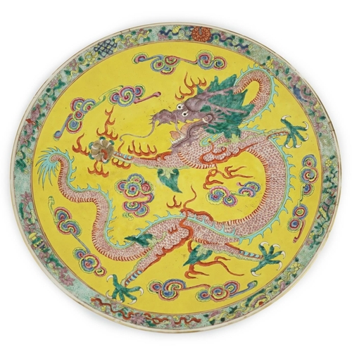 103 - A Chinese yellow ground dragon dish, late 19th century, painted with a five claw dragon chasing a ... 