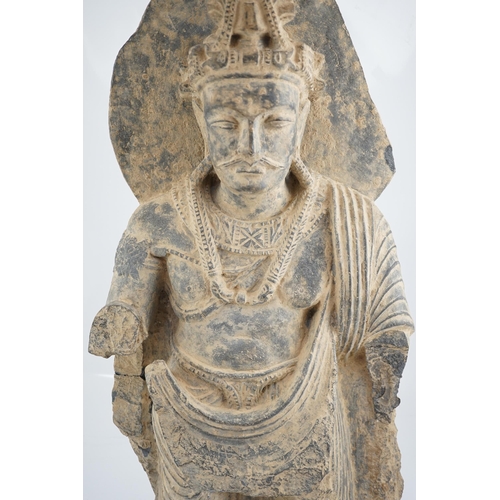 111 - A large grey schist Bodhisattva figure, Gandhara, 2nd/3rd century A.D., dressed in a flowing sangha... 