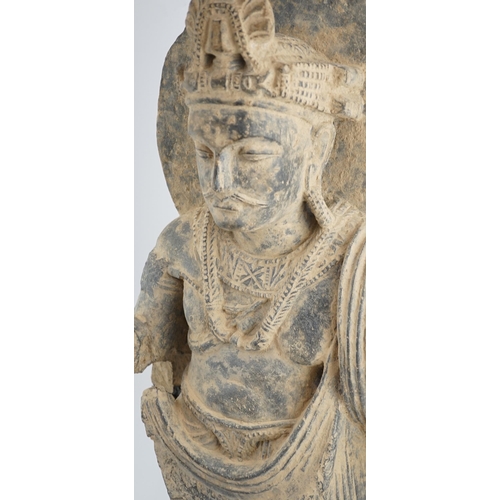 111 - A large grey schist Bodhisattva figure, Gandhara, 2nd/3rd century A.D., dressed in a flowing sangha... 
