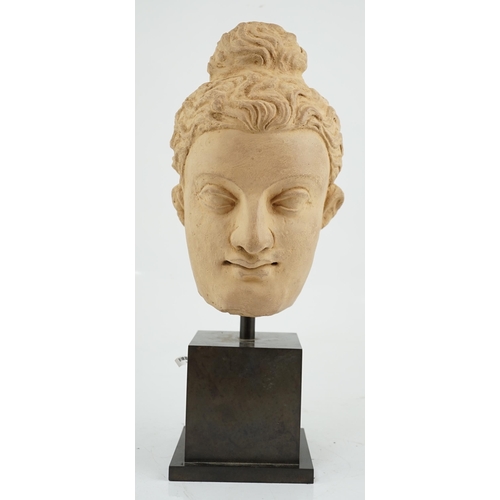 112 - A stucco head of Buddha, Gandhara, Kushan period, 3rd/4th century AD, 28cm high, excluding display s... 