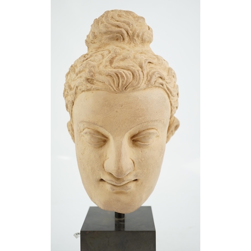 112 - A stucco head of Buddha, Gandhara, Kushan period, 3rd/4th century AD, 28cm high, excluding display s... 