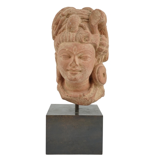 113 - A red stone head of Ardhanarishvara, Muthura region, India, Gupta period, c.5th century A.D., the fa... 