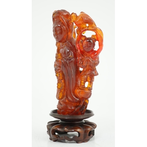 115 - A Chinese amber group of Guanyin, 19th century, carved in high relief and openwork with a figure of ... 