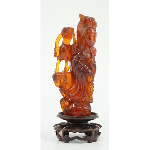 115 - A Chinese amber group of Guanyin, 19th century, carved in high relief and openwork with a figure of ... 