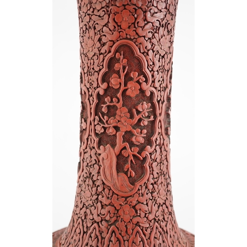 117 - A large Chinese cinnabar lacquer bottle vase, 19th century, carved in high relief with scholars and ... 