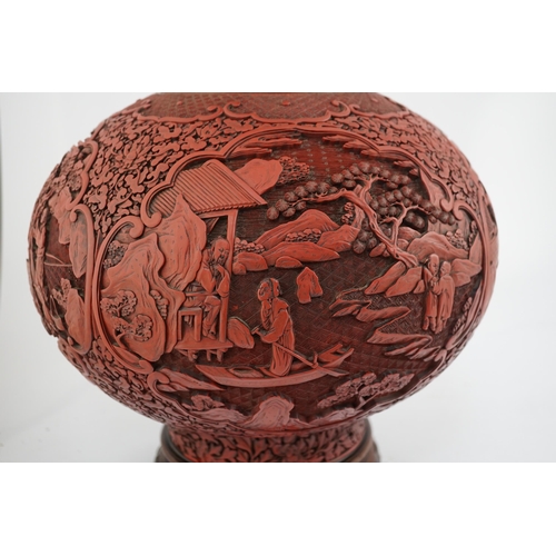 117 - A large Chinese cinnabar lacquer bottle vase, 19th century, carved in high relief with scholars and ... 