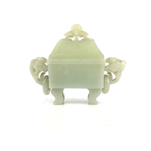 121 - A Chinese pale celadon jade rectangular vase and cover, 19th/20th century, with a pair of lotus ring... 