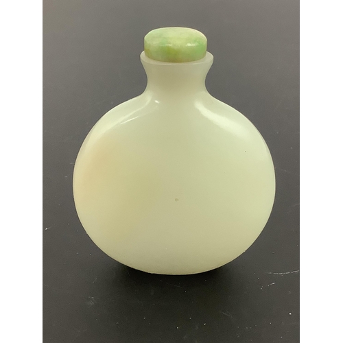123 - A Chinese pale celadon jade snuff bottle, of moonflask form, 19th century, the stone of good even to... 