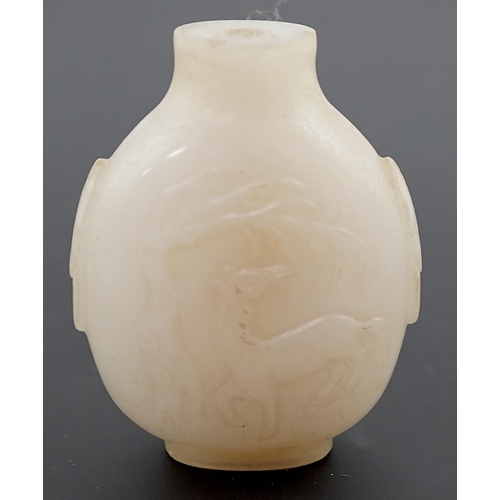 126 - A large Chinese white jade snuff bottle, 19th century, carved in relief with a horse biting leaves f... 