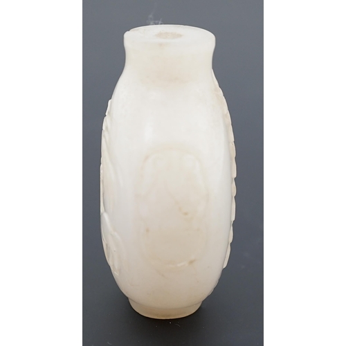 126 - A large Chinese white jade snuff bottle, 19th century, carved in relief with a horse biting leaves f... 