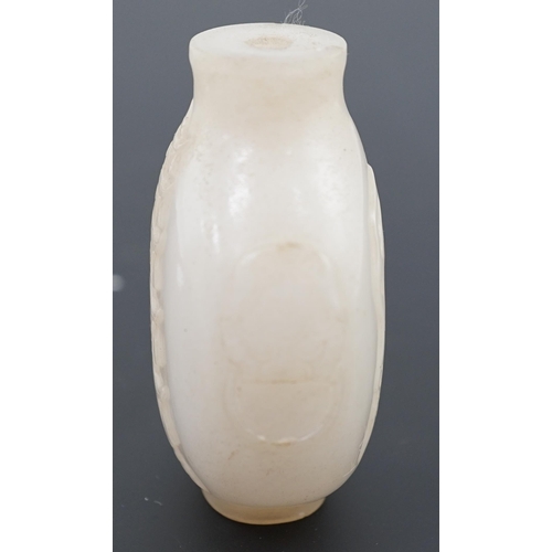 126 - A large Chinese white jade snuff bottle, 19th century, carved in relief with a horse biting leaves f... 