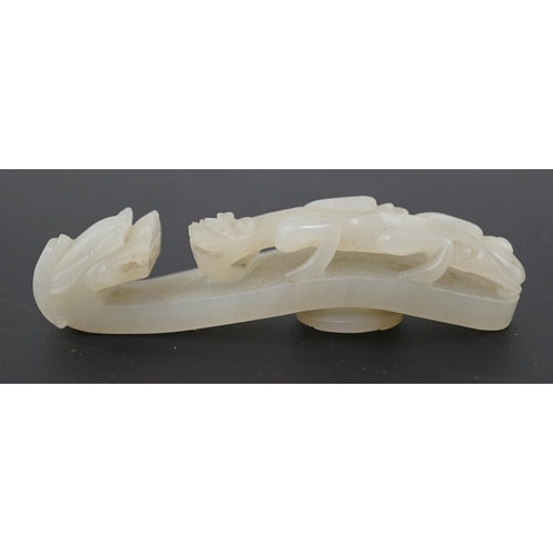 127 - A Chinese white jade dragon belt hook, 18th/19th century, carved in relief and openwork with a chi... 