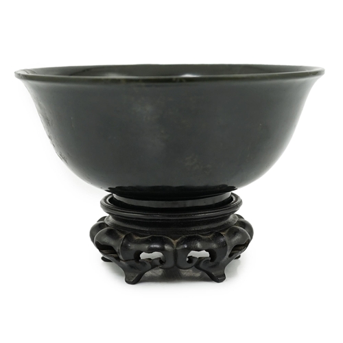 133 - A Chinese dark spinach green jade bowl, engraved Qianlong seal mark but 19th/20th century, the sligh... 