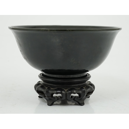 133 - A Chinese dark spinach green jade bowl, engraved Qianlong seal mark but 19th/20th century, the sligh... 