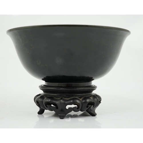 133 - A Chinese dark spinach green jade bowl, engraved Qianlong seal mark but 19th/20th century, the sligh... 