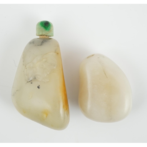 139 - Two Chinese jade pebble snuff bottles, 19th century, the larger pale celadon and russet skin jade sn... 