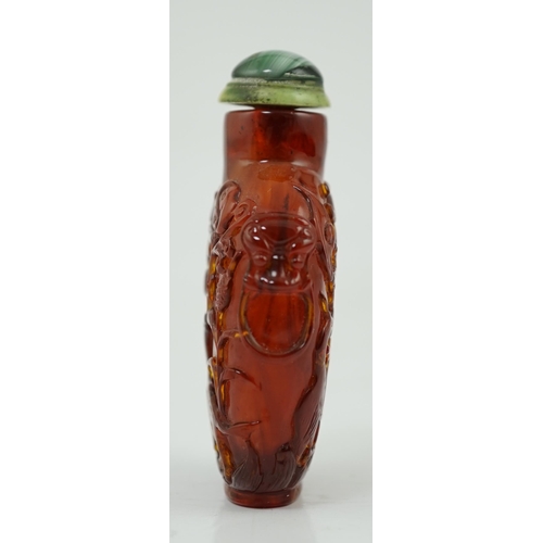 140 - A Chinese carved amber snuff bottle, 19th century, carved in relief with a horse, bird, yin-yang sym... 