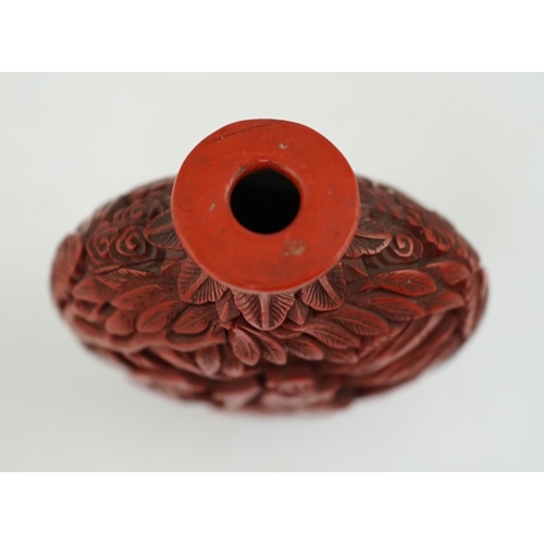 141 - A Chinese cinnabar lacquer snuff bottle, 19th century, of flattened ovoid form, carved in high relie... 