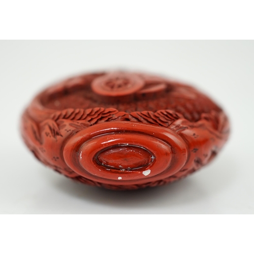 141 - A Chinese cinnabar lacquer snuff bottle, 19th century, of flattened ovoid form, carved in high relie... 