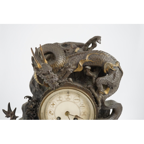 168 - A Japanese parcel gilt bronze dragon mantel clock, Meiji period, modelled with two dragons amongst... 