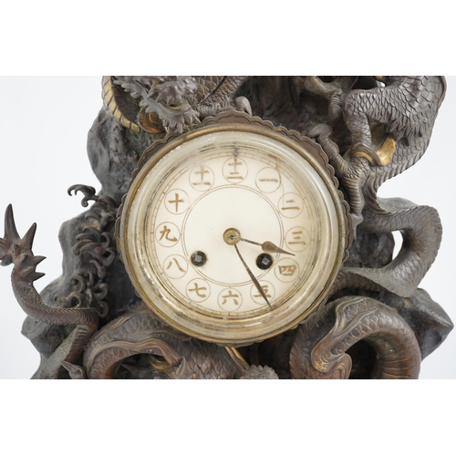 168 - A Japanese parcel gilt bronze dragon mantel clock, Meiji period, modelled with two dragons amongst... 