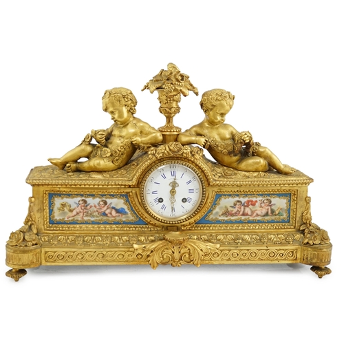 170 - A 19th century French ormolu and Sevres style porcelain mantel clock modelled with two putti reclini... 