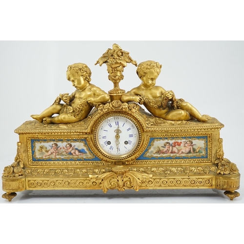 170 - A 19th century French ormolu and Sevres style porcelain mantel clock modelled with two putti reclini... 