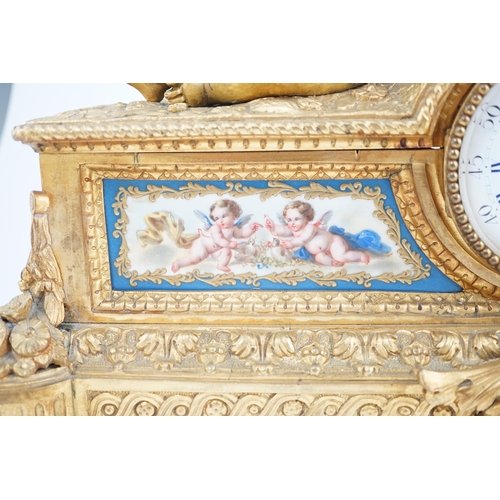 170 - A 19th century French ormolu and Sevres style porcelain mantel clock modelled with two putti reclini... 