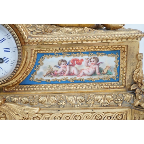 170 - A 19th century French ormolu and Sevres style porcelain mantel clock modelled with two putti reclini... 