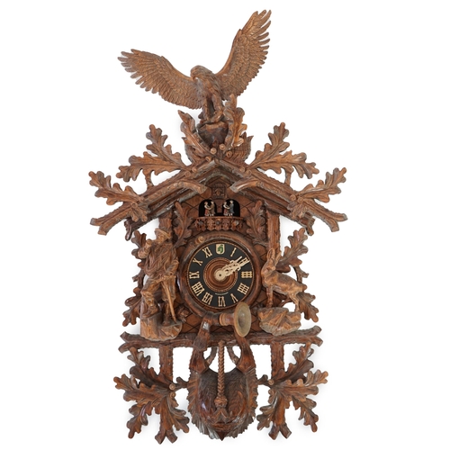 179 - A Hönes Black Forest carved wood cuckoo clock with eagle finial, alpine climber and Chamonix figures... 