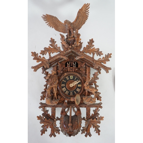 179 - A Hönes Black Forest carved wood cuckoo clock with eagle finial, alpine climber and Chamonix figures... 
