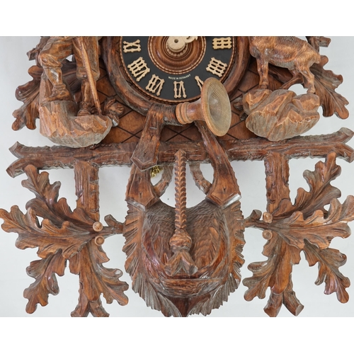 179 - A Hönes Black Forest carved wood cuckoo clock with eagle finial, alpine climber and Chamonix figures... 