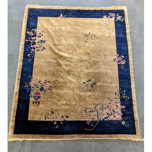 185 - A Walter Nichols Chinese champagne ground carpet with asymmetrical decoration of flowers and an urn,... 