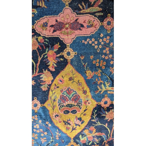 186 - A Khorassan Mashhad red ground carpet, circa 1930s, with field of stylised floral motif medallions,... 